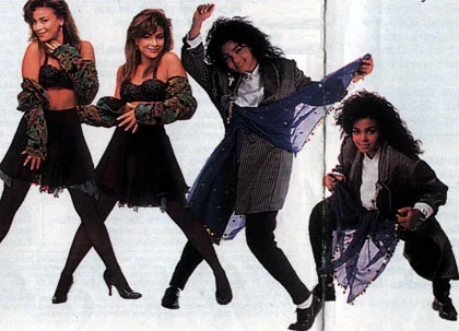 Paula Abdul and Janet Jackson posing with dancers